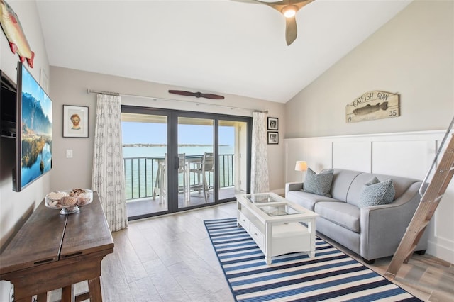 7540 Sunshine Skyway Ln S Unit 217, Saint Petersburg, FL 33711 - living room featuring a ceiling fan, vaulted ceiling, wood finished floors, and a water view