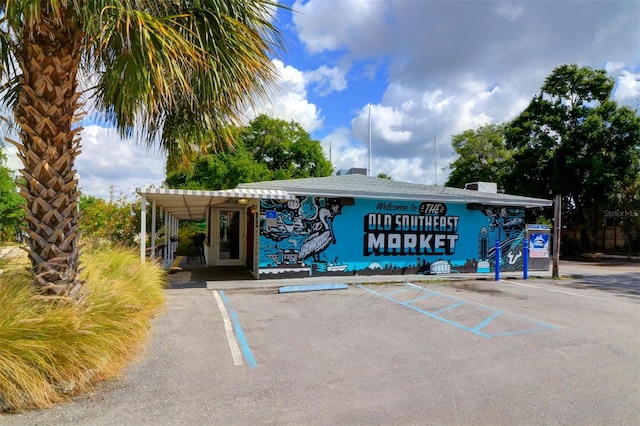 view of building exterior with uncovered parking