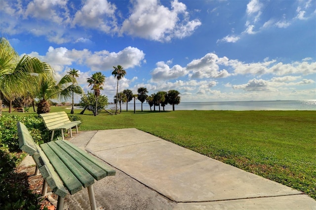 view of home's community with a yard and a water view