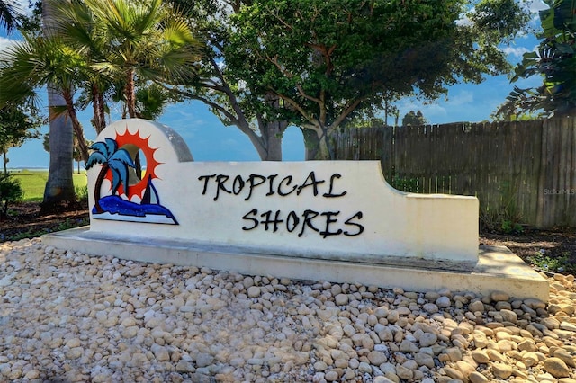 community / neighborhood sign with fence
