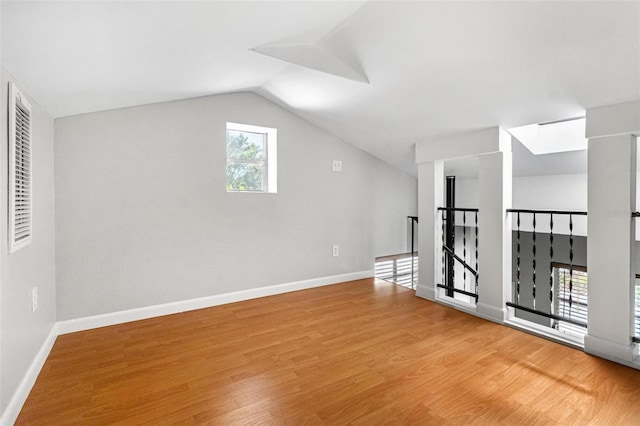 bonus room featuring light wood finished floors, vaulted ceiling, and baseboards