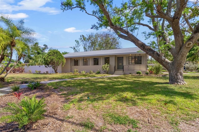 ranch-style house with fence, a porch, and a front yard