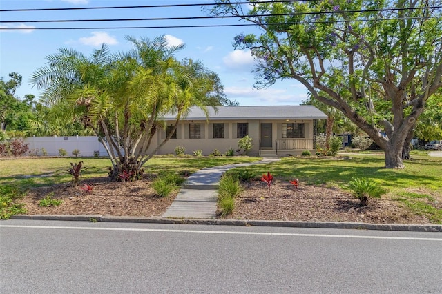 single story home featuring fence, covered porch, and a front yard