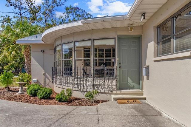 property entrance with stucco siding