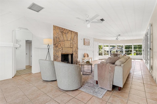 living room featuring light tile patterned floors, visible vents, and ceiling fan