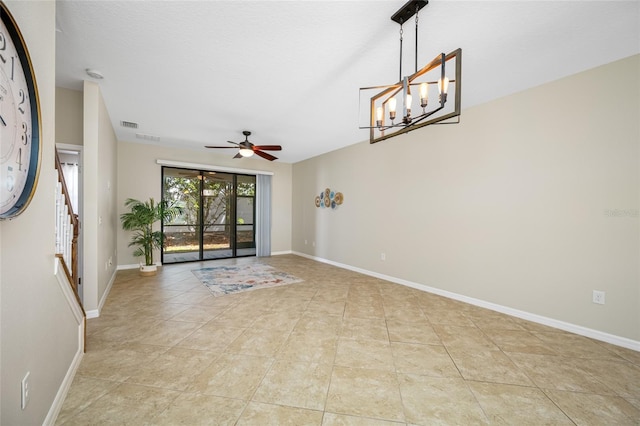 2527 Silverback Ct, Palm Harbor, FL 34684 - spare room with stairs, ceiling fan with notable chandelier, light tile patterned floors, baseboards, and visible vents