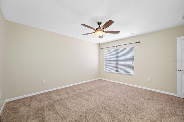 2527 Silverback Ct, Palm Harbor, FL 34684 - spare room with a ceiling fan, baseboards, and carpet