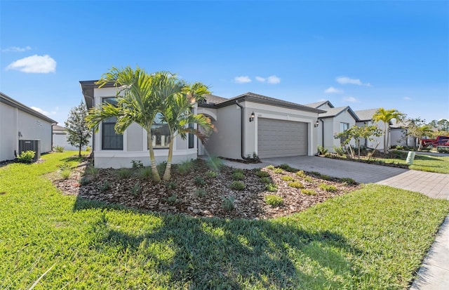 2528 Charter Oak Dr, North Port, FL 34289 - ranch-style home with driveway, an attached garage, cooling unit, a front yard, and stucco siding