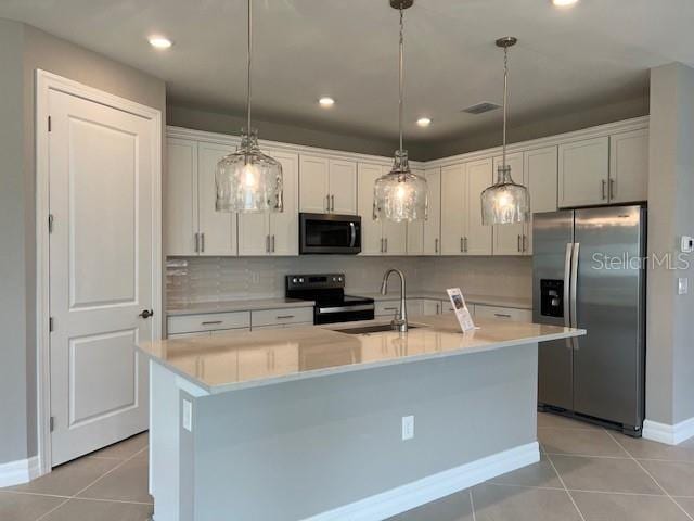 2528 Charter Oak Dr, North Port, FL 34289 - kitchen with light countertops, a sink, light tile patterned floors, baseboards, and appliances with stainless steel finishes