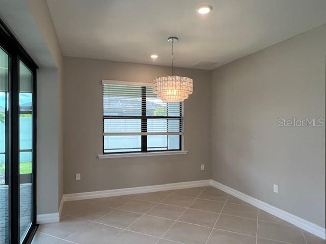 2528 Charter Oak Dr, North Port, FL 34289 - unfurnished room featuring a notable chandelier, baseboards, light tile patterned flooring, and recessed lighting
