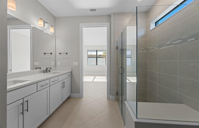 2528 Charter Oak Dr, North Port, FL 34289 - bathroom with plenty of natural light, tile patterned flooring, a shower stall, and double vanity