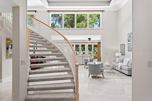 stairway with plenty of natural light and a high ceiling