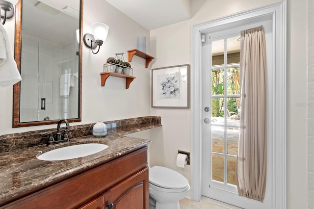 full bathroom with tile patterned floors, vanity, toilet, and a stall shower