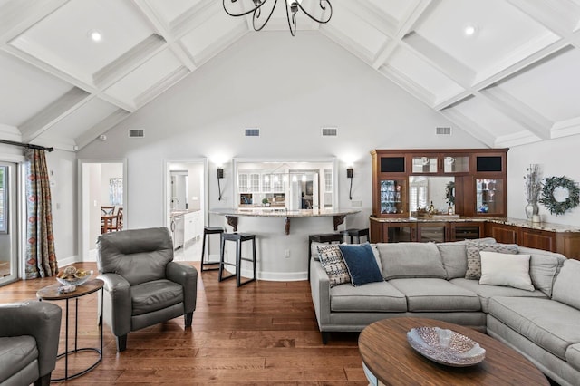 living room with beam ceiling, high vaulted ceiling, visible vents, dark wood-type flooring, and a chandelier