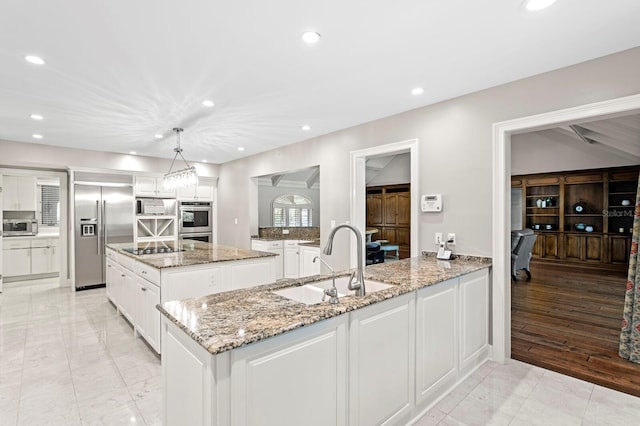 kitchen featuring a sink, recessed lighting, white cabinetry, and appliances with stainless steel finishes