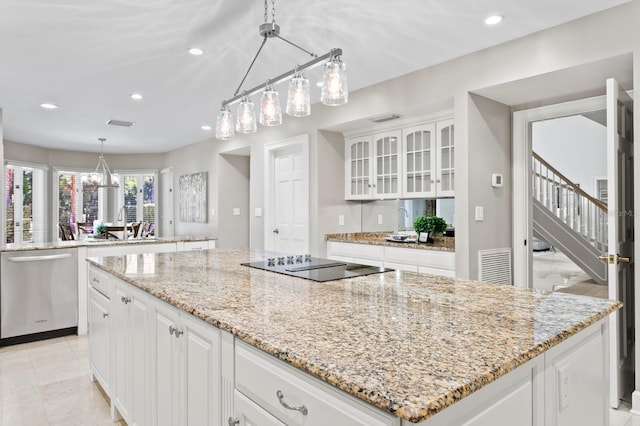 kitchen featuring recessed lighting, black electric stovetop, a center island, and dishwasher