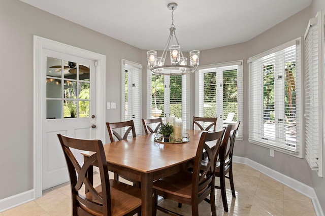 dining area featuring a chandelier, baseboards, and light tile patterned floors