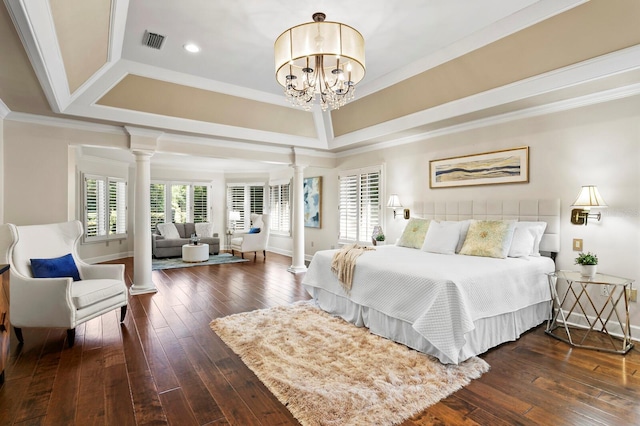 bedroom featuring visible vents, ornate columns, and dark wood-type flooring
