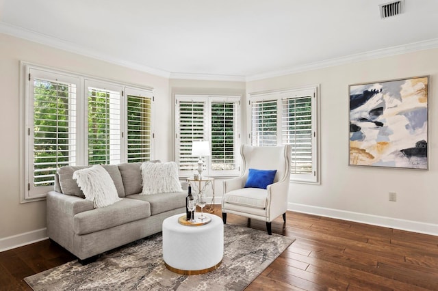 living area featuring hardwood / wood-style flooring, ornamental molding, baseboards, and a healthy amount of sunlight