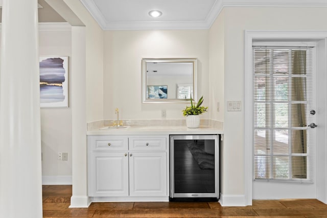 bar featuring a sink, dark wood finished floors, a wealth of natural light, wet bar, and wine cooler