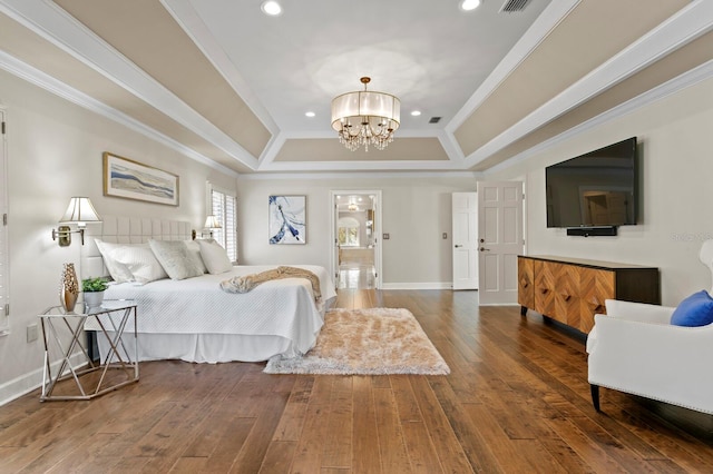 bedroom featuring a tray ceiling, recessed lighting, an inviting chandelier, crown molding, and hardwood / wood-style floors