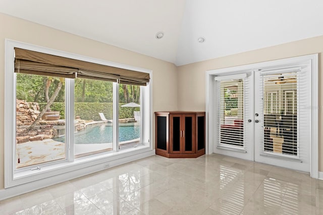 unfurnished room featuring ceiling fan and high vaulted ceiling