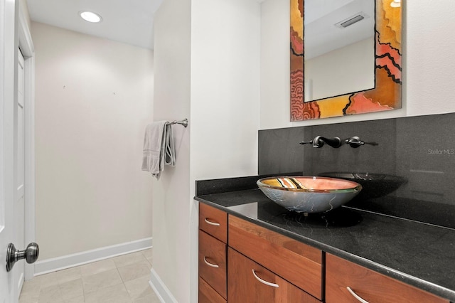 bathroom featuring baseboards, tile patterned flooring, vanity, and recessed lighting