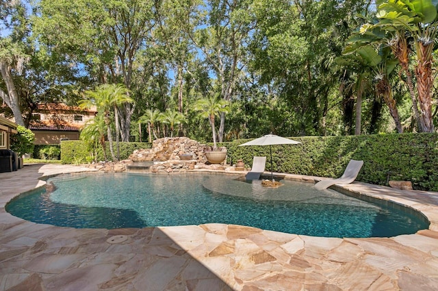 view of swimming pool featuring a patio area and a fenced in pool