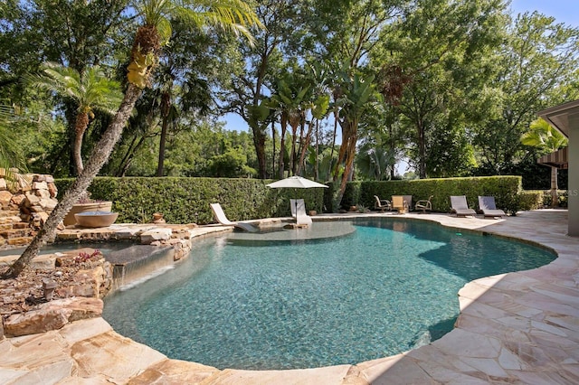 view of swimming pool featuring fence, a fenced in pool, and a patio area