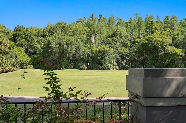 view of home's community featuring a lawn and view of golf course