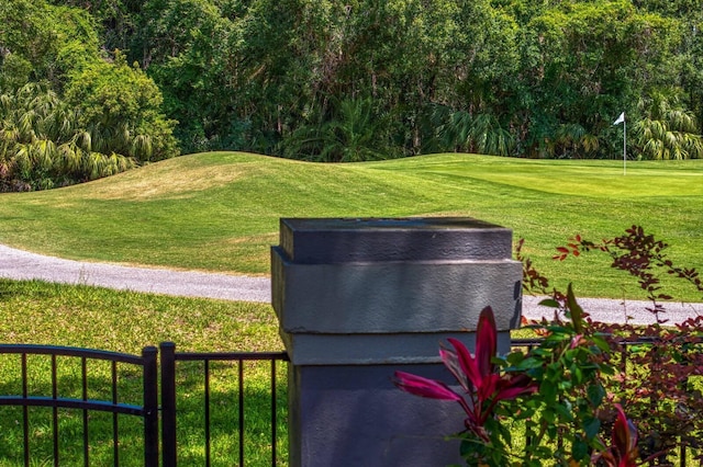 exterior details with golf course view and fence