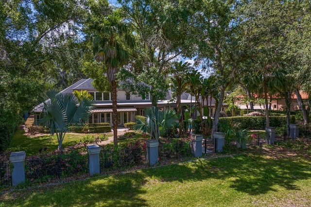 back of property with a fenced front yard and a yard