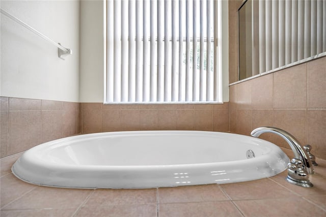 bathroom featuring tile patterned floors and a garden tub