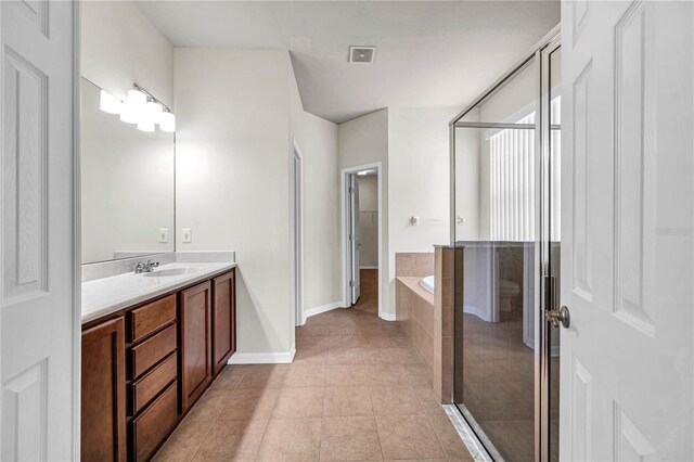 full bathroom with tile patterned flooring, vanity, baseboards, visible vents, and a stall shower