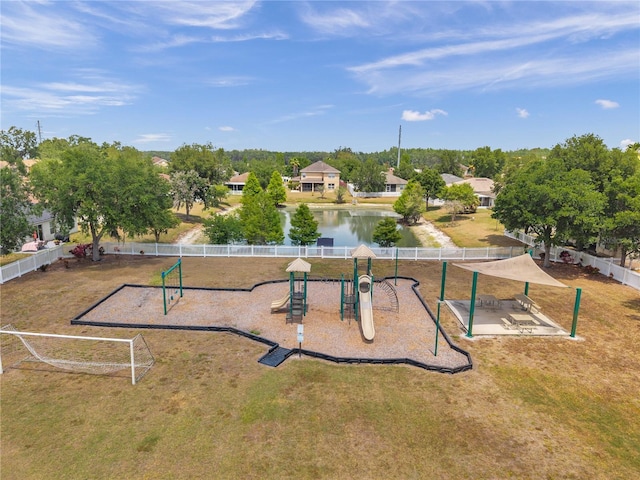 surrounding community featuring fence, a water view, a yard, and playground community