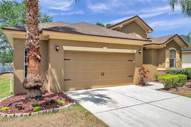 view of front of house with a garage, stucco siding, a shingled roof, and concrete driveway
