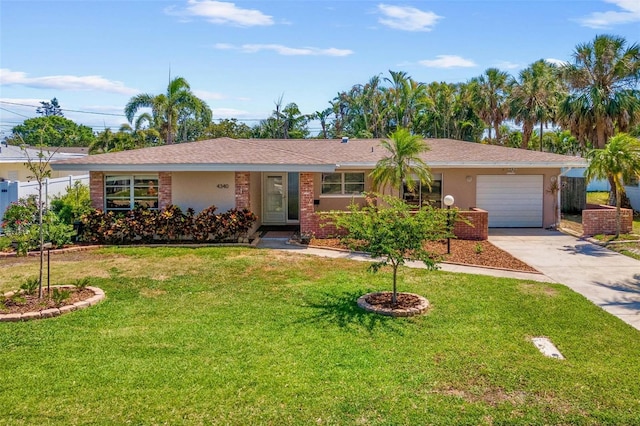 4340 50th Ter S, Saint Petersburg, FL 33711 - ranch-style home featuring concrete driveway, an attached garage, fence, and a front lawn