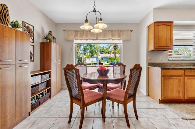 4340 50th Ter S, Saint Petersburg, FL 33711 - dining space featuring a healthy amount of sunlight, light tile patterned floors, and a notable chandelier