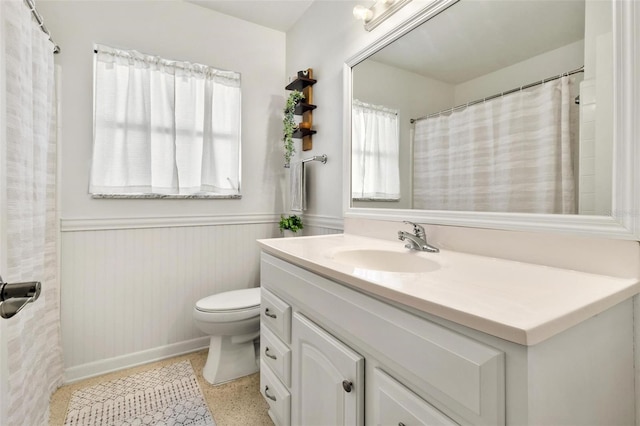 4340 50th Ter S, Saint Petersburg, FL 33711 - bathroom with a wainscoted wall, vanity, toilet, and speckled floor