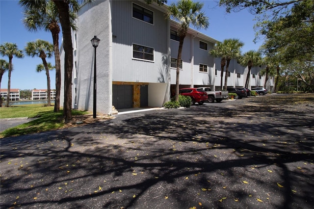 view of building exterior featuring a garage and driveway