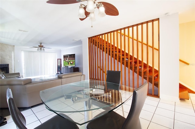 dining space featuring a ceiling fan and light tile patterned floors