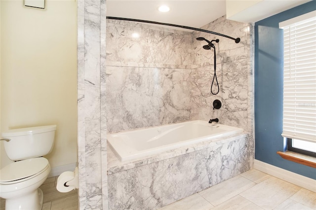 full bath with toilet, tiled shower / bath, baseboards, and tile patterned flooring