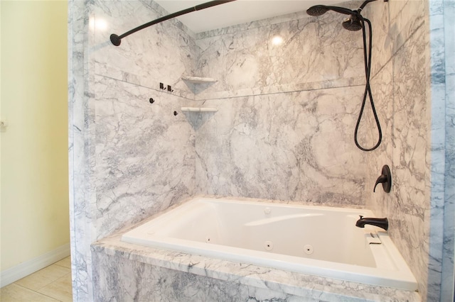 bathroom with a combined bath / shower with jetted tub, baseboards, and tile patterned floors