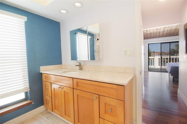bathroom with recessed lighting, baseboards, and vanity