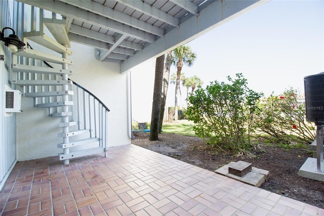 view of patio with stairs and cooling unit