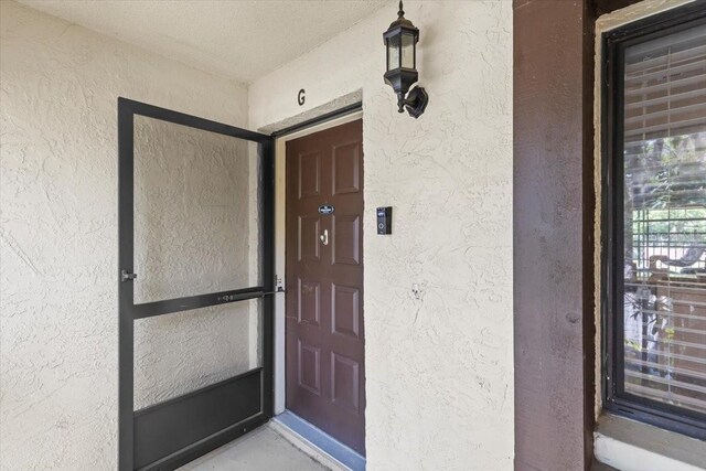 3600 Magnolia Ridge Cir Unit 1221-G, Palm Harbor, FL 34684 - property entrance featuring stucco siding