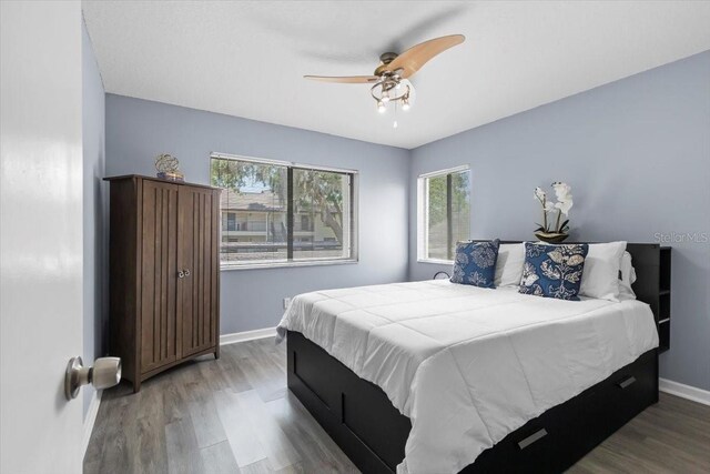 3600 Magnolia Ridge Cir Unit 1221-G, Palm Harbor, FL 34684 - bedroom featuring ceiling fan, wood finished floors, and baseboards