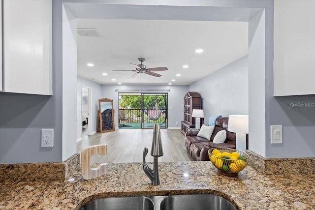3600 Magnolia Ridge Cir Unit 1221-G, Palm Harbor, FL 34684 - kitchen featuring a sink, visible vents, open floor plan, light stone countertops, and a ceiling fan