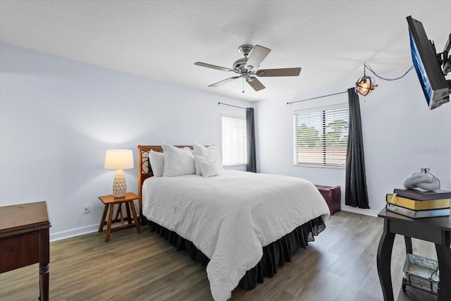 3600 Magnolia Ridge Cir Unit 1221-G, Palm Harbor, FL 34684 - bedroom featuring baseboards, wood finished floors, and ceiling fan