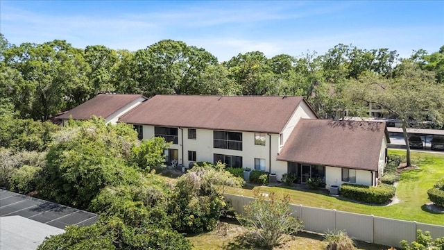 3600 Magnolia Ridge Cir Unit 1221-G, Palm Harbor, FL 34684 - exterior space featuring a front yard, stucco siding, and fence